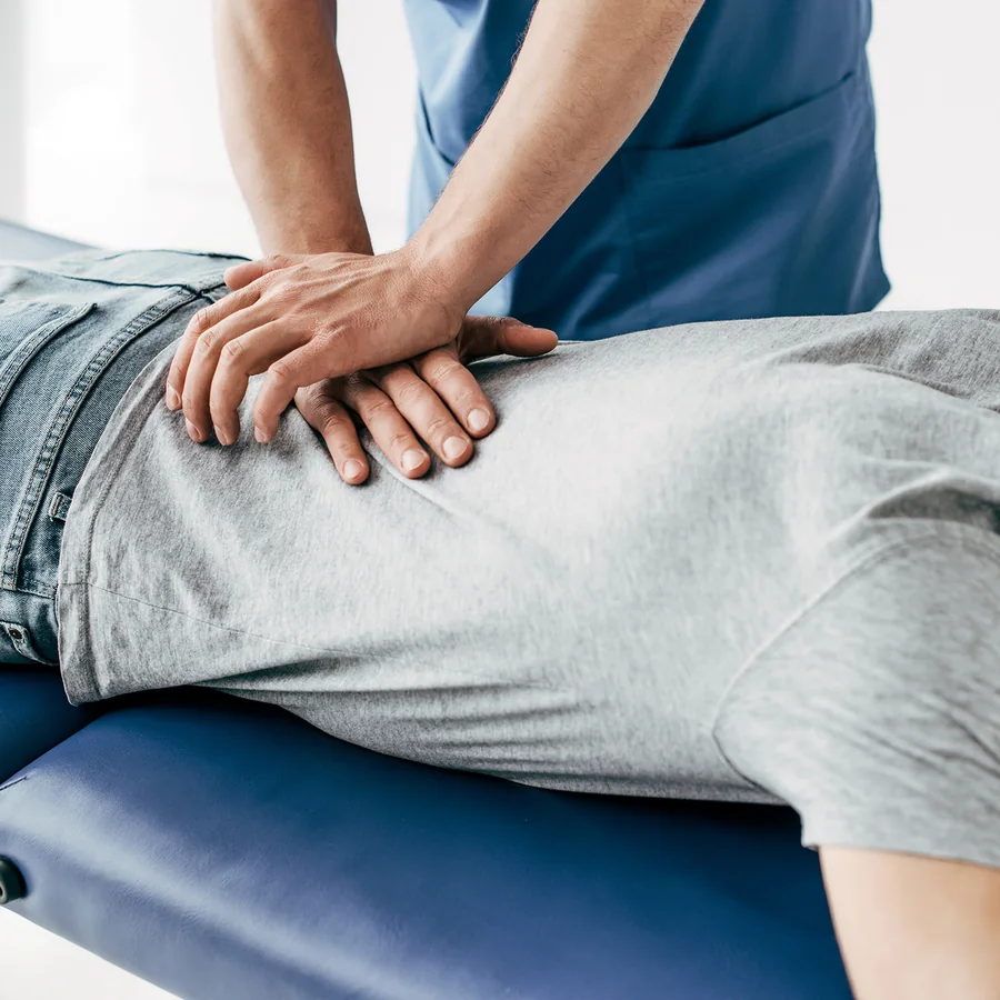 A patient receiving hands-on chiropractic care at Magnolia Medical Group